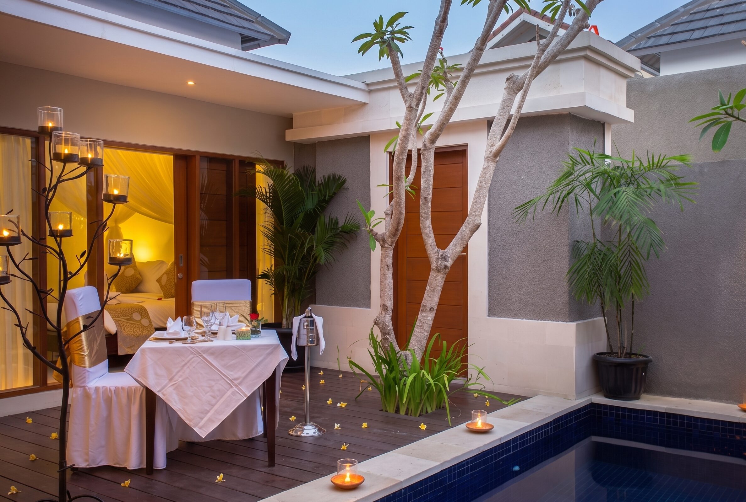 Romantic candlelit dinner setup by the pool at The Light Exclusive Villas & Spa, Seminyak, Bali.