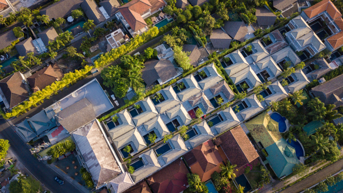 Aerial view of luxury villas surrounded by lush greenery in Seminyak, Bali.