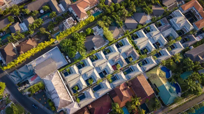 Aerial view of luxury villas surrounded by lush greenery in Seminyak, Bali.