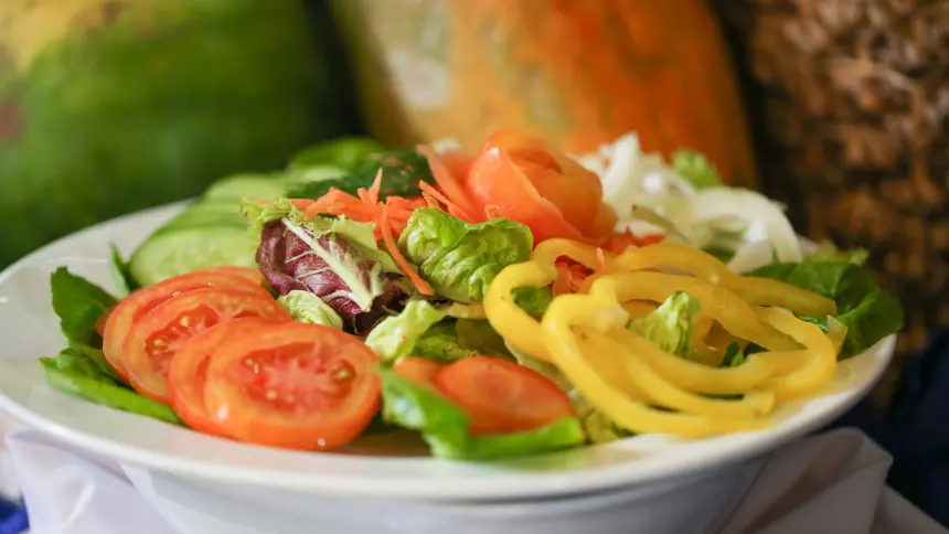 Fresh tropical salad with sliced tomatoes, cucumbers, bell peppers, and crisp lettuce at The Light Exclusive Villas & Spa dining.