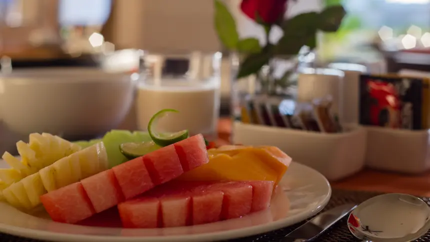 Fresh tropical fruit platter with watermelon, pineapple, and papaya at The Light Exclusive Villas & Spa dining table.