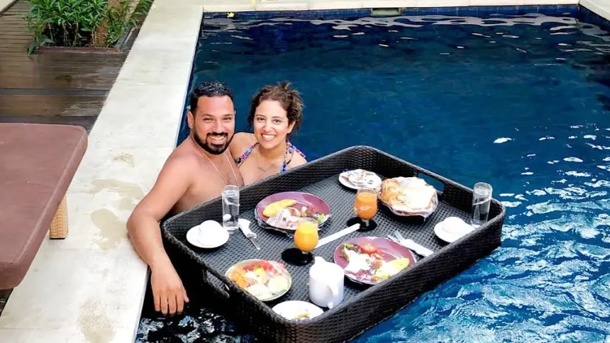 Couple enjoying a luxurious floating breakfast in the private pool at The Light Exclusive Villas & Spa, Bali.