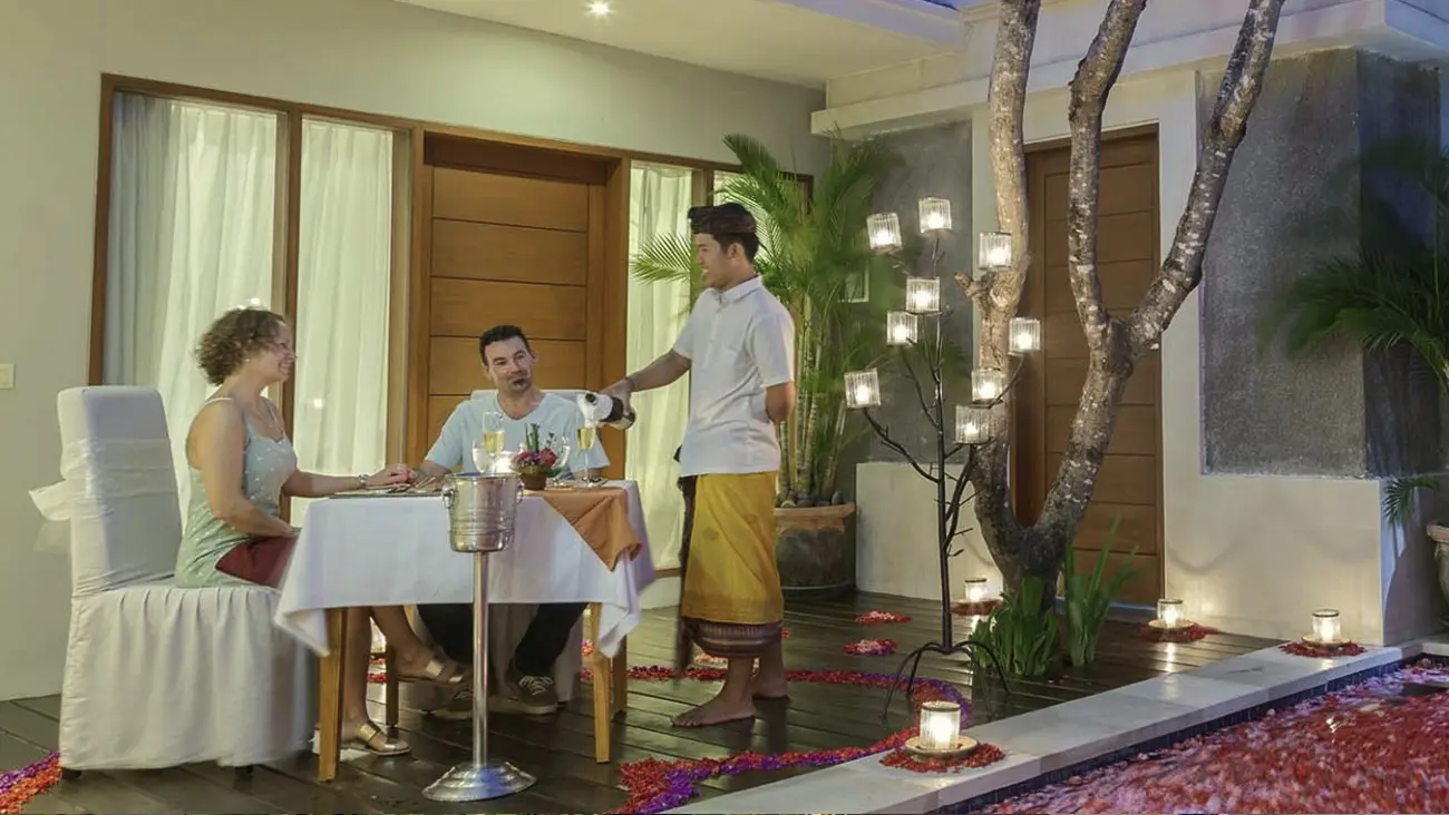 Couple dining by candlelight with personal service at The Light Exclusive Villas & Spa amidst a romantic, tropical ambiance.
