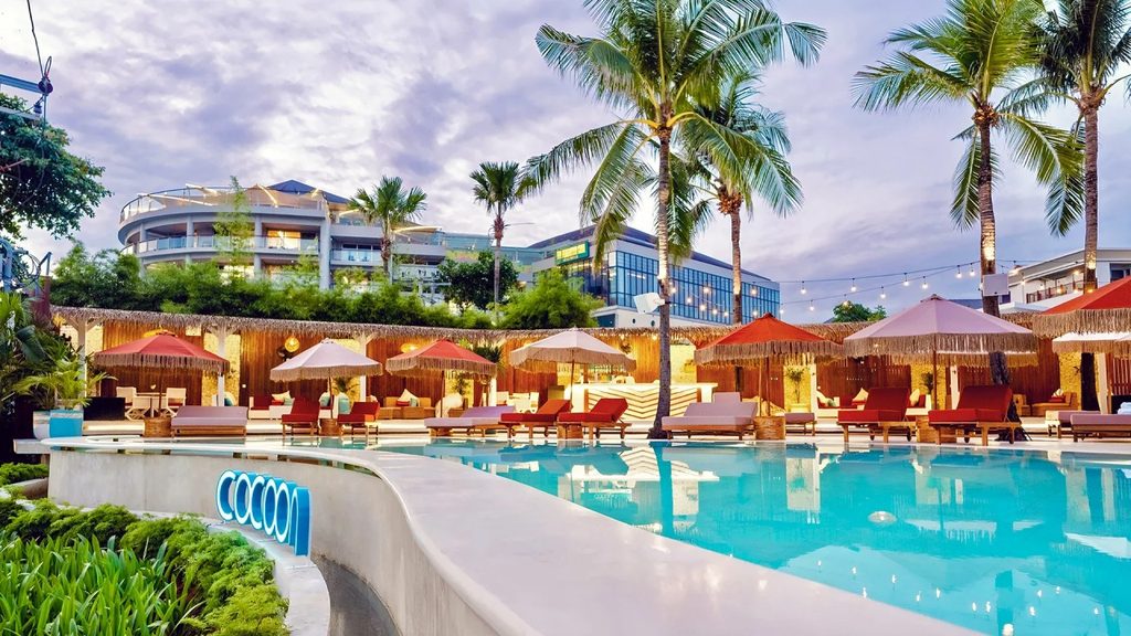 Cocoon Seminyak pool with sun loungers and cabanas