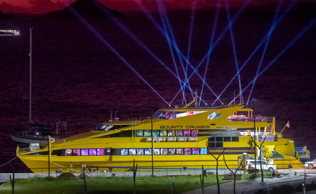 Bounty Cruise ship illuminated against a vibrant sunset sky, offering an enchanting evening experience in Bali.